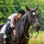 A kid enjoying ride on a horse